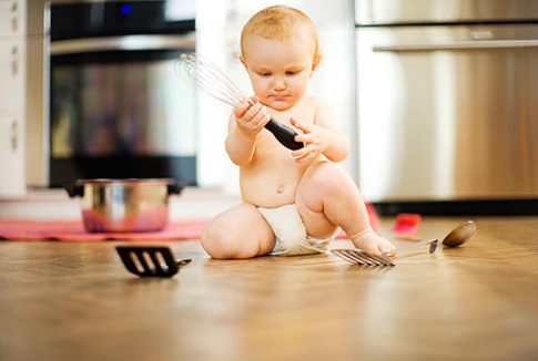 young boy playing with kitchen utensils Original Filename: 85255603.jpg
