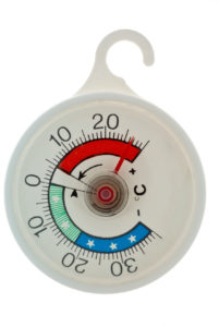 white circular fridge or freezer thermometer in isolation